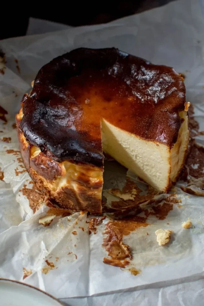 Delicious Burnt Basque Cheesecake topped with vibrant Raspberry Coulis