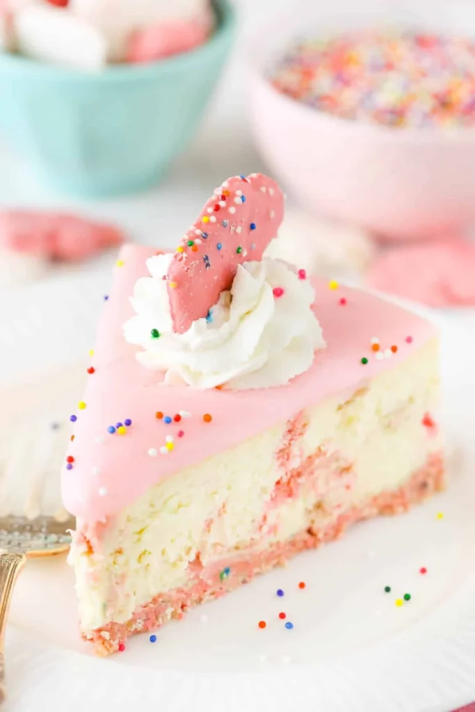 Creamy frosted animal cookie cheesecake with colorful cookies on top