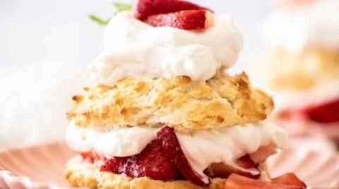 Slice of old-fashioned strawberry shortcake on a white plate