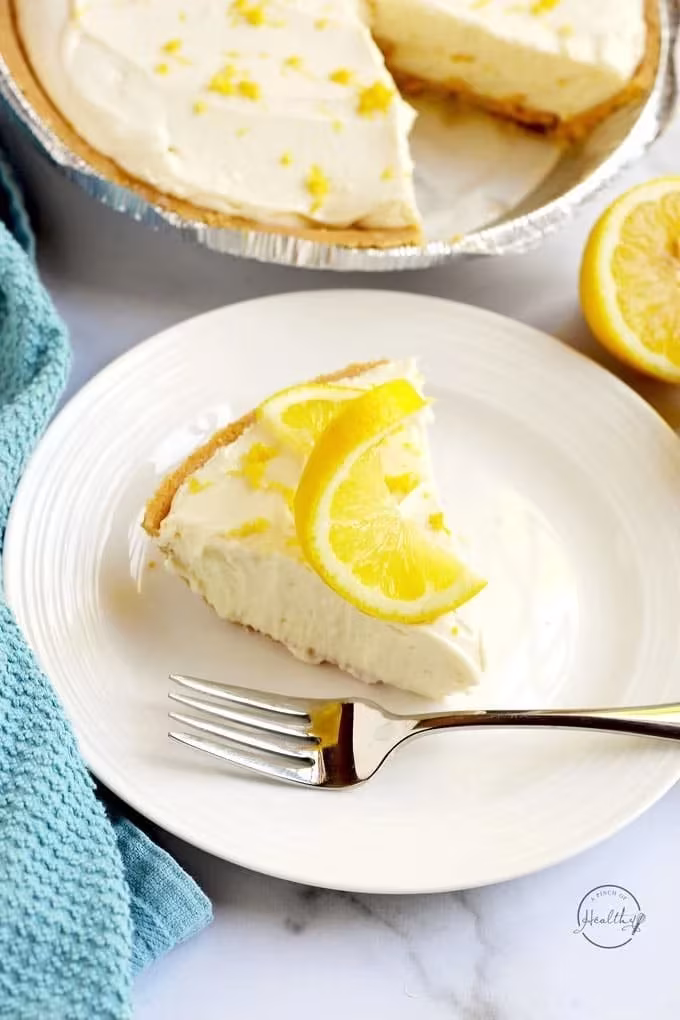 Slice of creamy lemon no-bake cheesecake topped with lemon zest