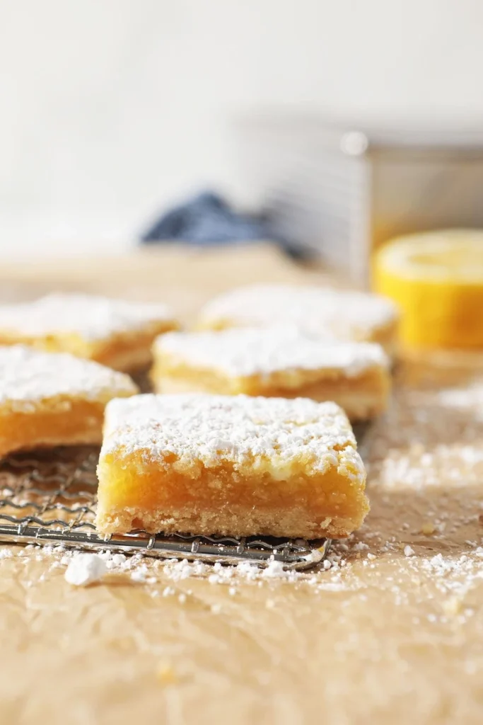 Delicious homemade easy lemon bars on a white plate.