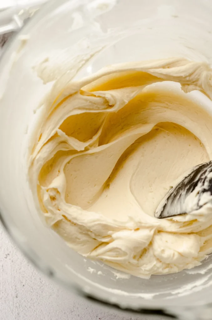 Creamy homemade vanilla buttercream frosting in a bowl with a spatula