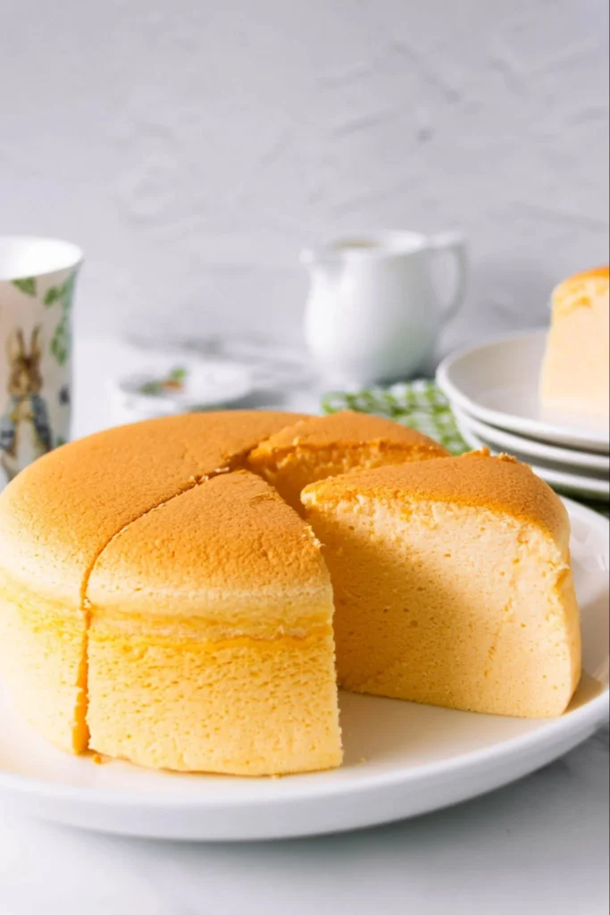 Light fluffy Japanese cotton cheesecake slice on a plate with berries.