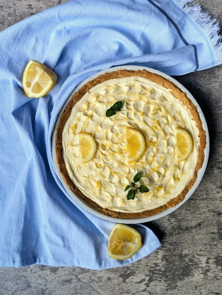 No-bake lemon cheesecake with graham cracker crust on a plate