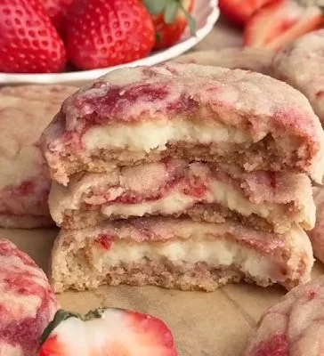 Delicious strawberry cheesecake cookies with fresh strawberries and creamy frosting.