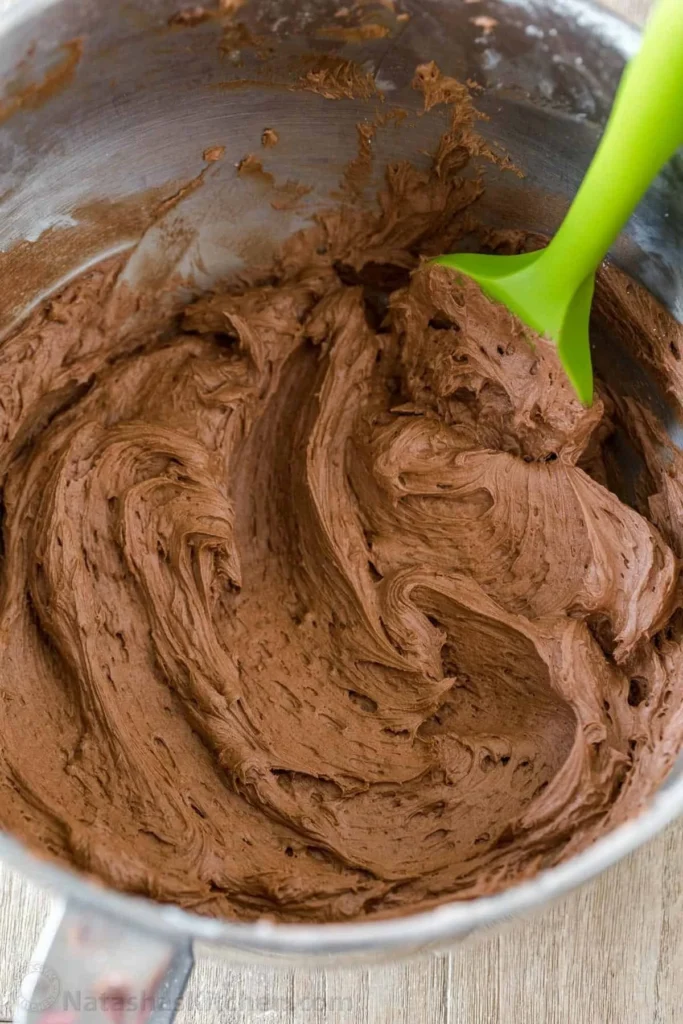 Delicious homemade Chocolate Buttercream Frosting spread on a cake