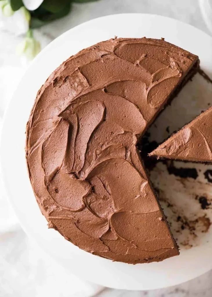 Decadent Chocolate Buttercream Frosting spread on a chocolate cake.