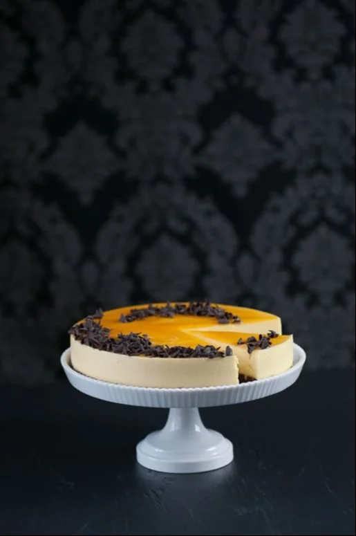 Creamy Passion Fruit Mousse Cake 4 Creamy passion fruit mousse cake topped with fresh fruit, perfect for dessert.