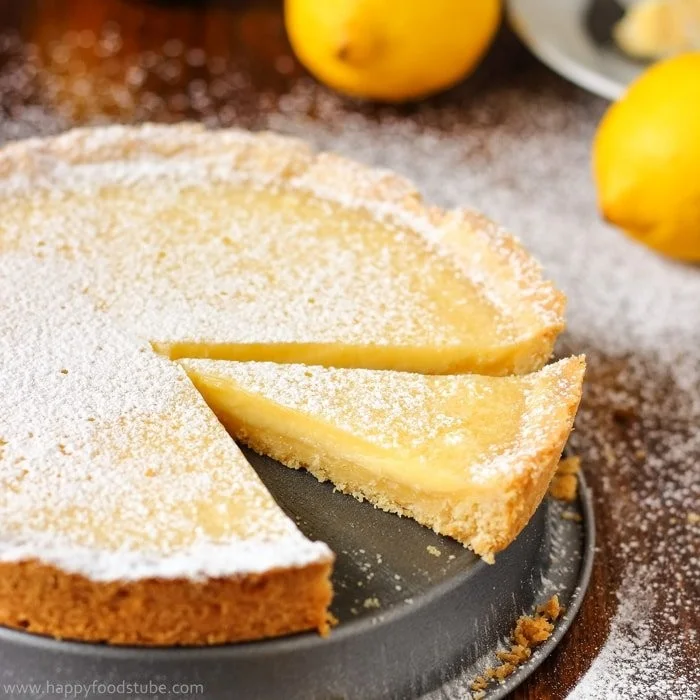 Easy Homemade Lemon Tart 4 Delicious homemade lemon tart garnished with fresh lemon slices and mint leaves.