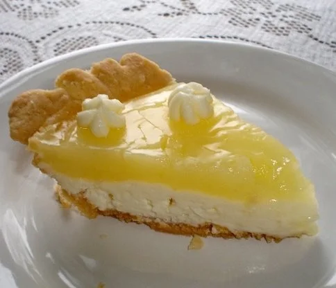 Lemon Cream Cheese Pie Recipe 4 Slice of Lemon Cream Cheese Pie topped with lemon zest and cream