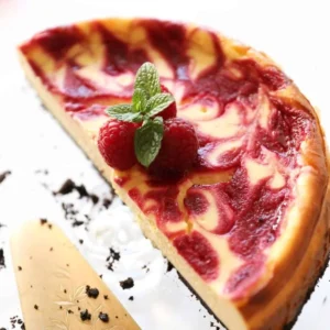 Raspberry Swirl Cheesecake with fresh raspberries and creamy filling