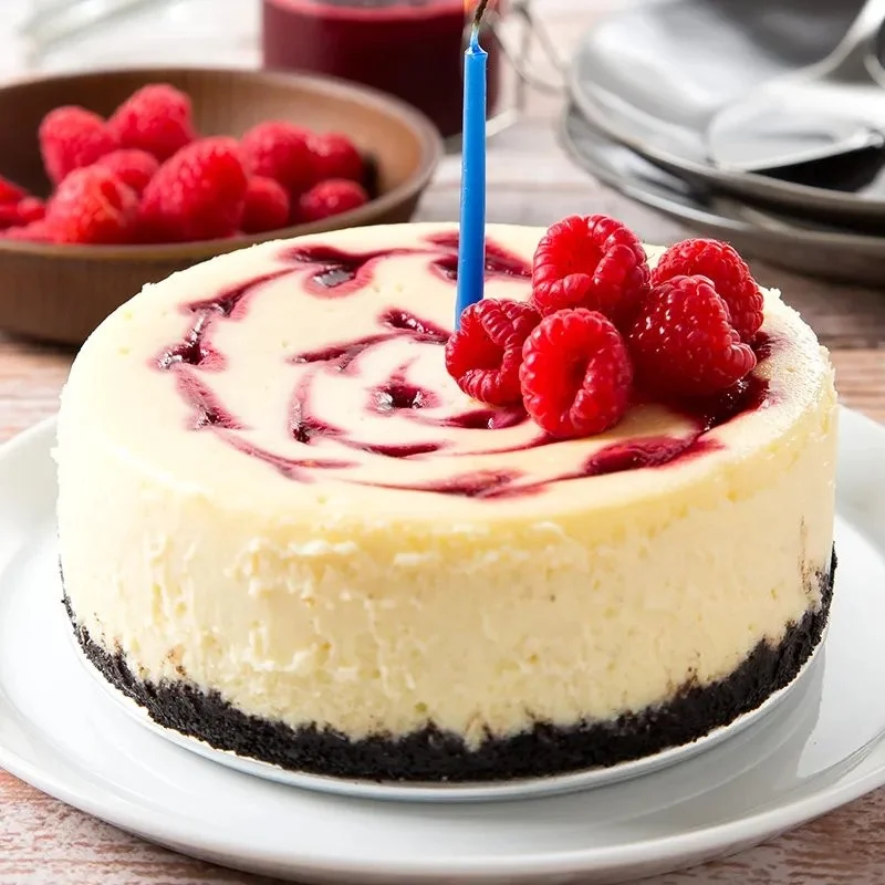 Delicious Raspberry Swirl Cheesecake with a fruity topping