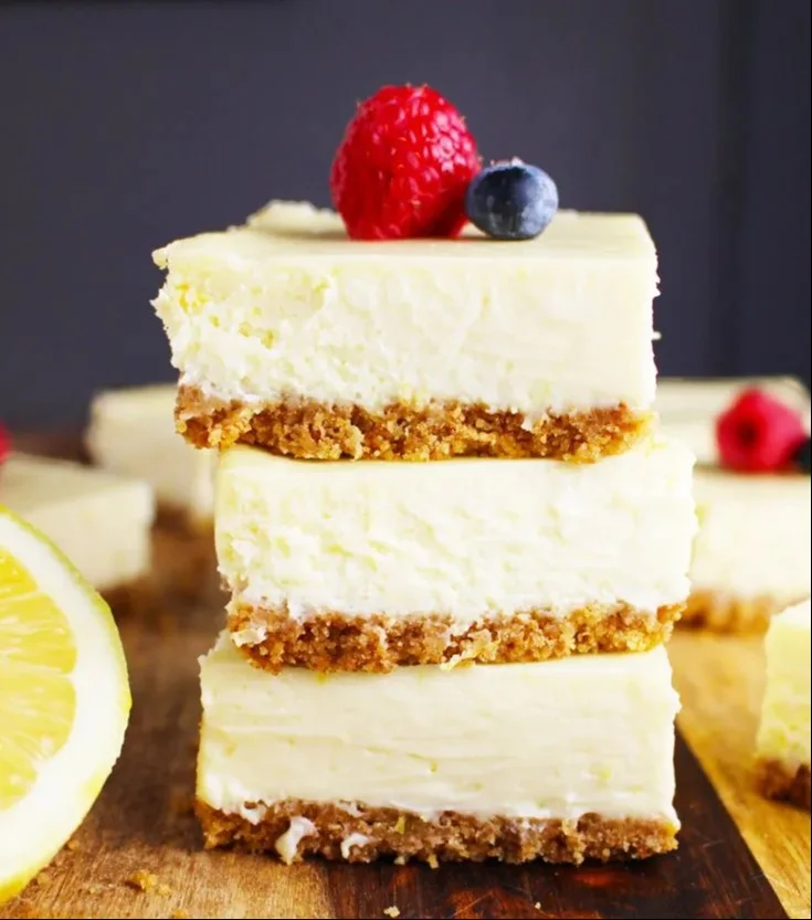 Zesty Lemon Cheesecake Bars 4 Delicious zesty lemon cheesecake bars topped with fresh lemon zest